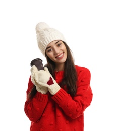 Young woman with cup of hot coffee on white background. Winter season
