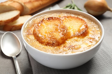 Tasty homemade french onion soup served on grey table