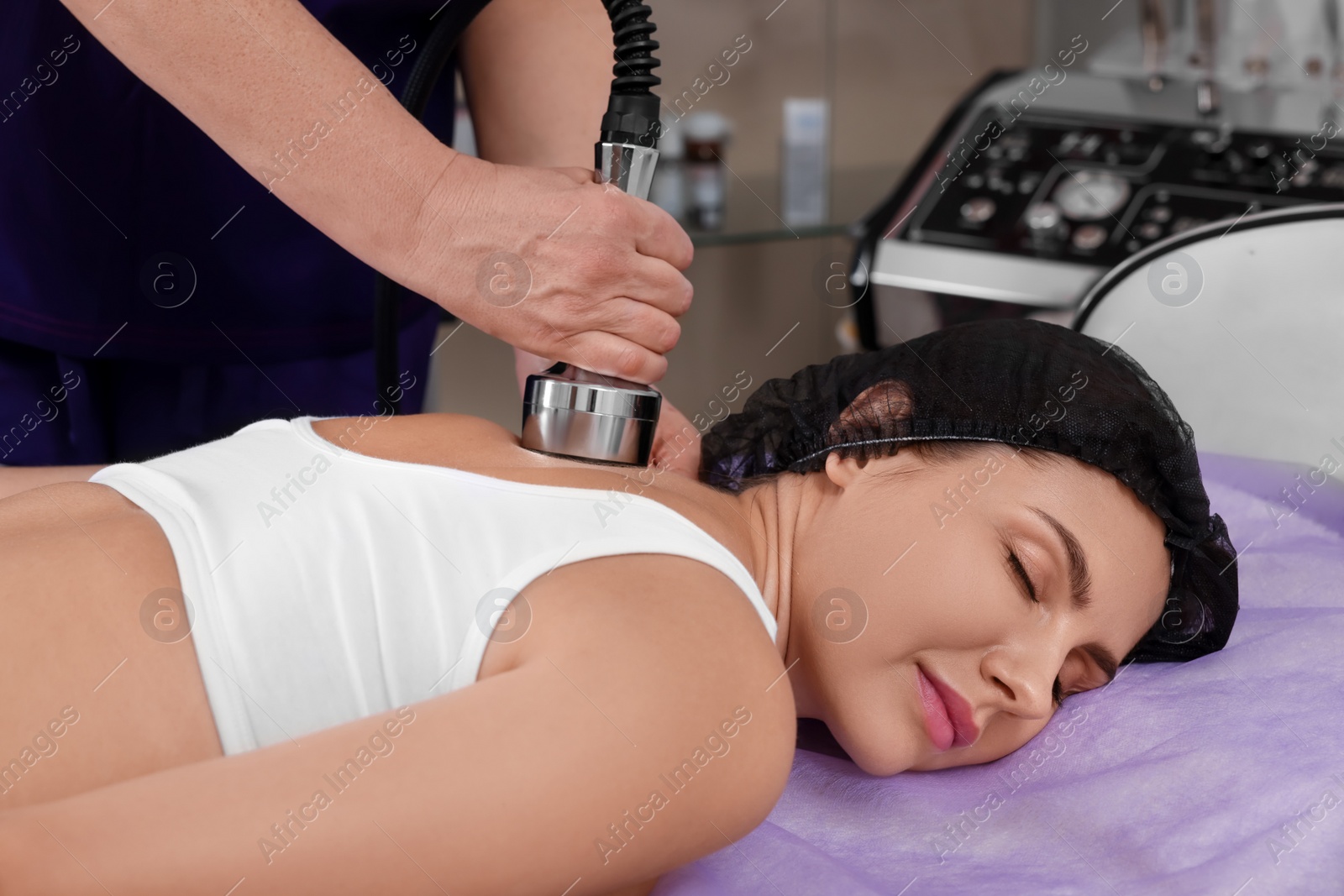 Photo of Woman undergoing radio frequency lifting procedure in beauty salon, closeup