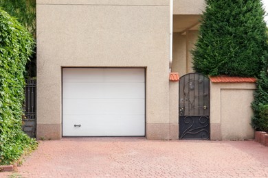 Photo of Building with white sectional garage door near entrance