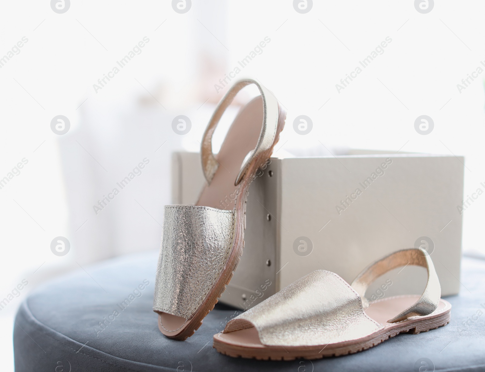 Photo of Female shoes on pouf in store