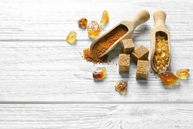 Photo of Various kinds of sugar on wooden background