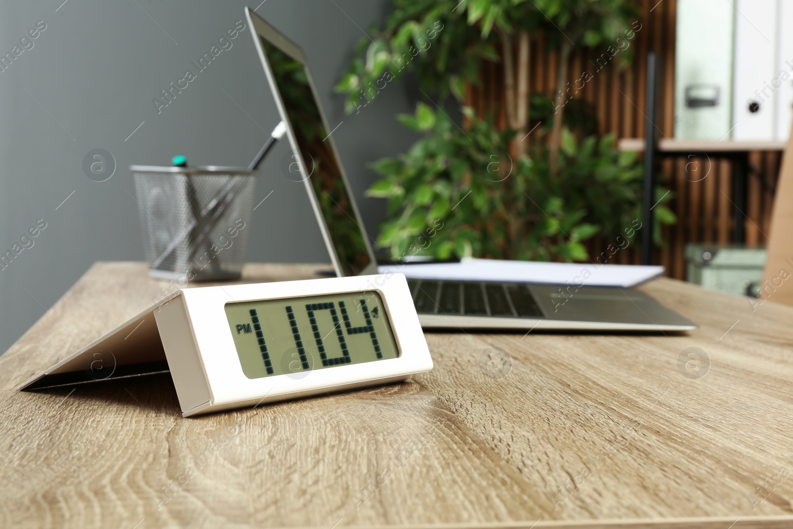 Photo of Digital clock on table in office, space for text. Time management