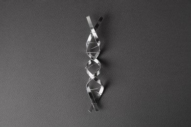 DNA molecular chain model made of metal on grey background, top view