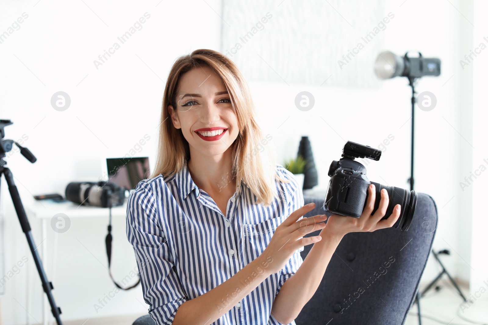 Photo of Portrait of female photo blogger with camera at home