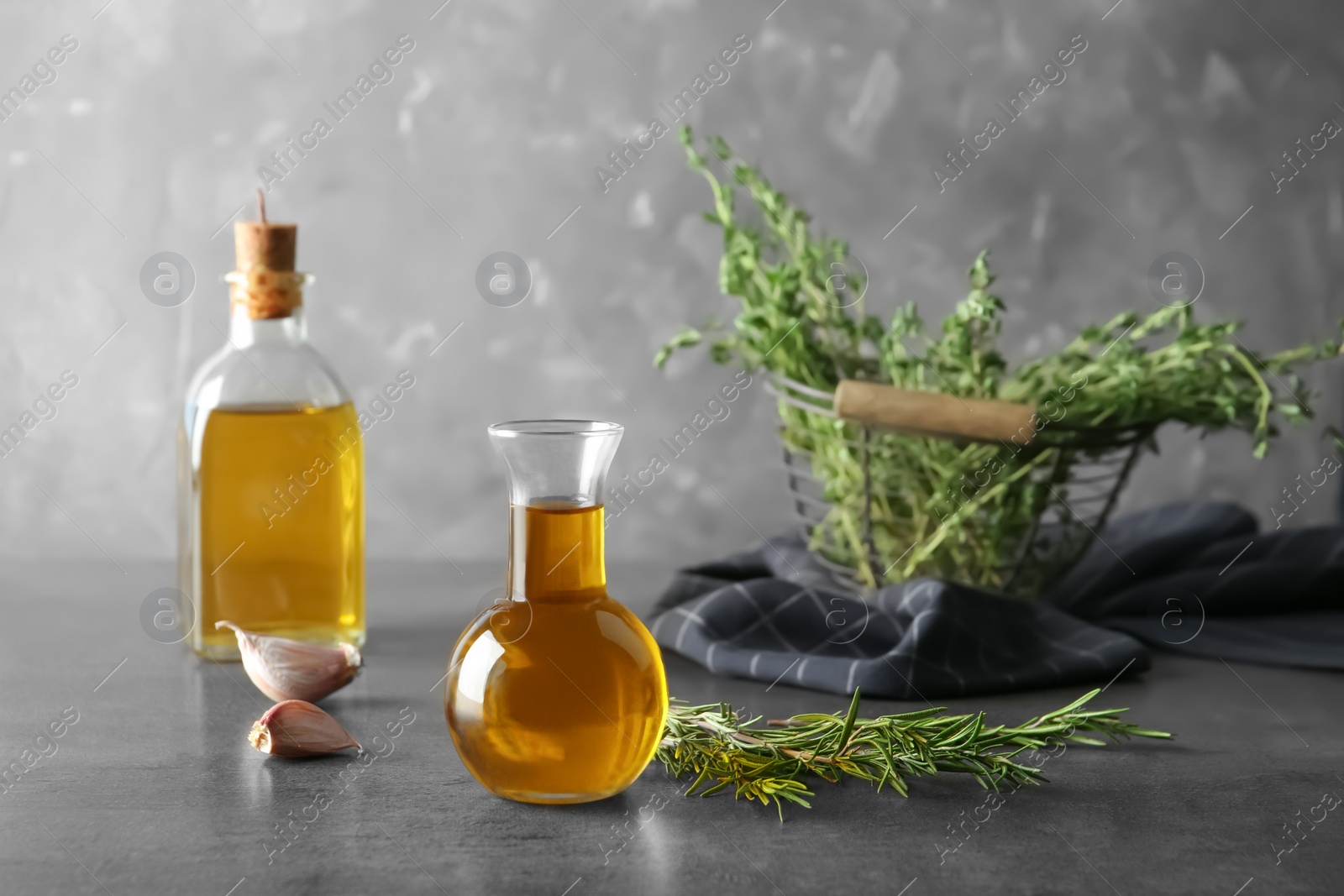 Photo of Composition with fresh rosemary oil on table