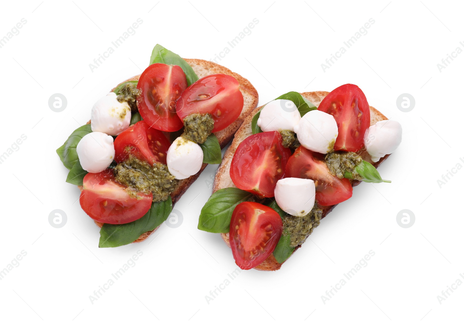 Photo of Delicious Caprese sandwiches with mozzarella, tomatoes, basil and pesto sauce isolated on white, top view