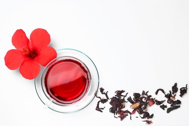 Delicious hibiscus tea and flowers on white background, flat lay. Space for text