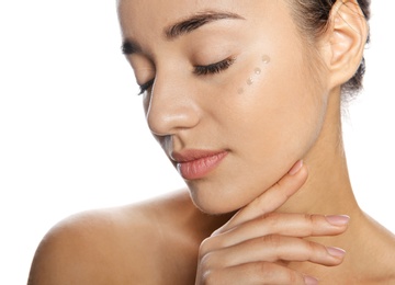 Photo of Portrait of young woman with liquid foundation on her face against white background