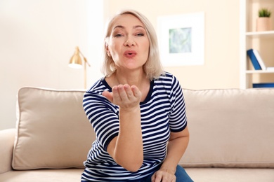 Photo of Mature woman using video chat at home, view from web camera