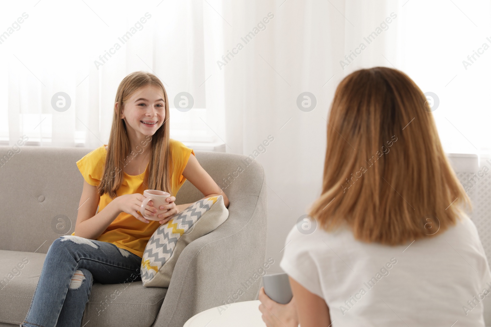 Photo of Mother talking with her teenager daughter at home