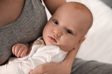 Photo of Young woman with her little baby resting after breast feeding, closeup