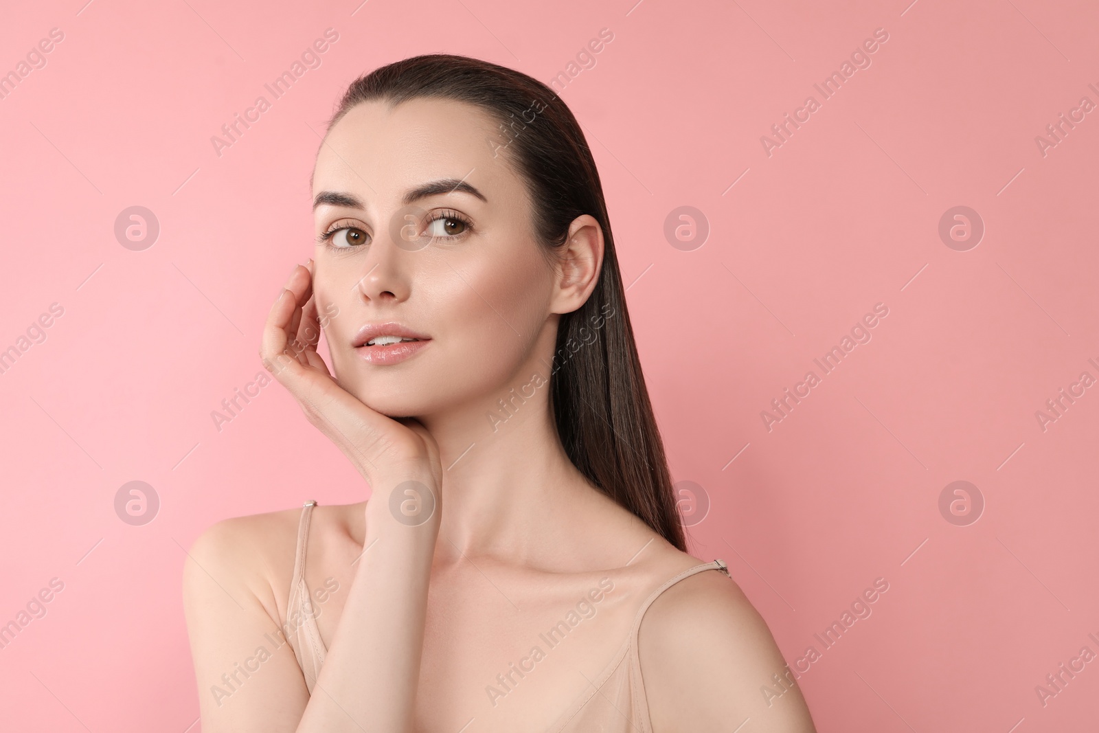 Photo of Portrait of beautiful young woman on pink background. Space for text