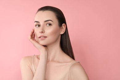 Portrait of beautiful young woman on pink background. Space for text