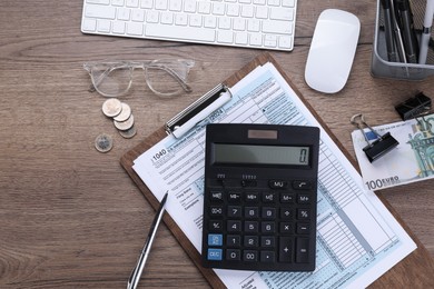 Photo of Tax accounting. Flat lay composition with calculator and document on wooden table