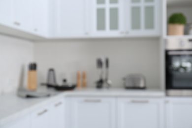 Photo of Blurred view of modern stylish kitchen interior