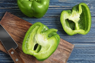 Photo of Raw ripe paprika peppers on wooden table, top view