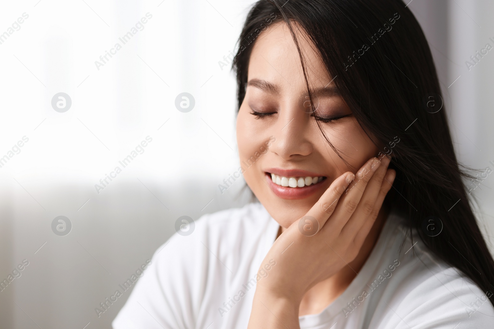 Photo of Portrait of beautiful woman with perfect skin at home