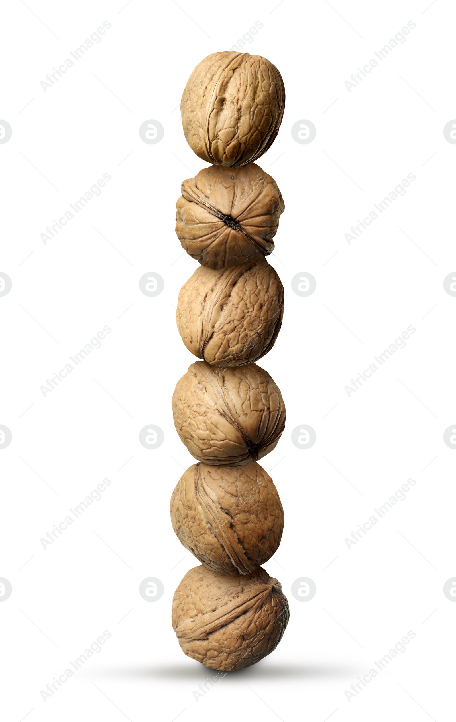 Image of Stack of many walnuts on white background