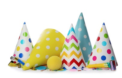 Colorful party hats and other festive items on white background