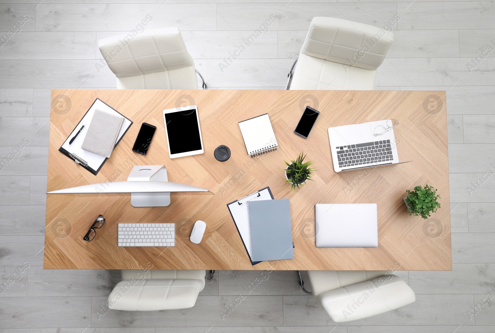 Photo of Modern office table with devices and chairs, top view