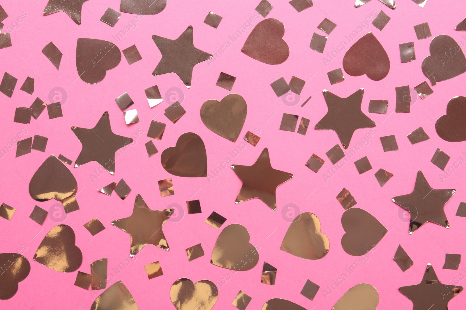 Photo of Shiny confetti on pink background, flat lay