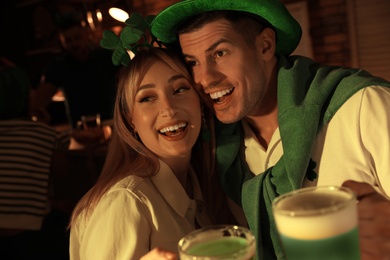 Couple with beer celebrating St Patrick's day in pub