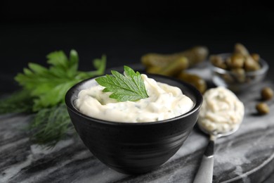 Photo of Tasty tartar sauce on marble board, closeup