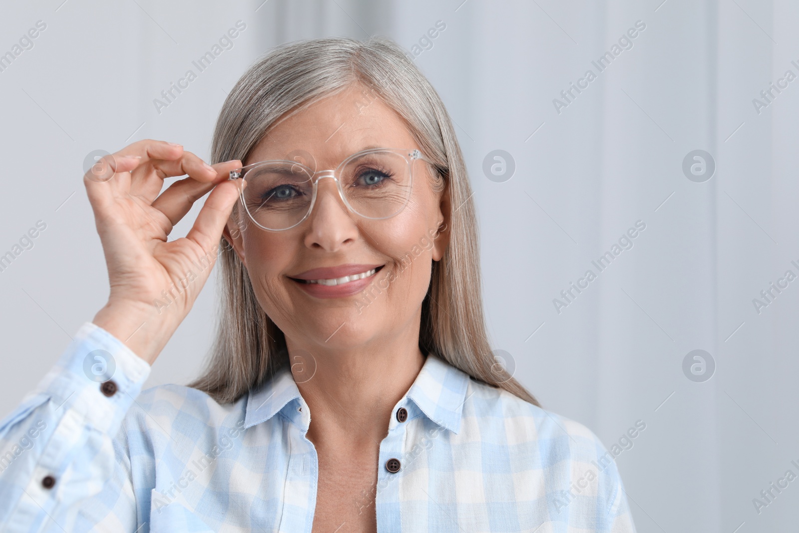 Photo of Portrait of beautiful senior woman in glasses indoors. Space for text