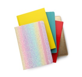 Stack of different colorful hardcover planners on white background, top view