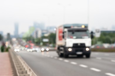 Photo of Blurred view of city road with cars