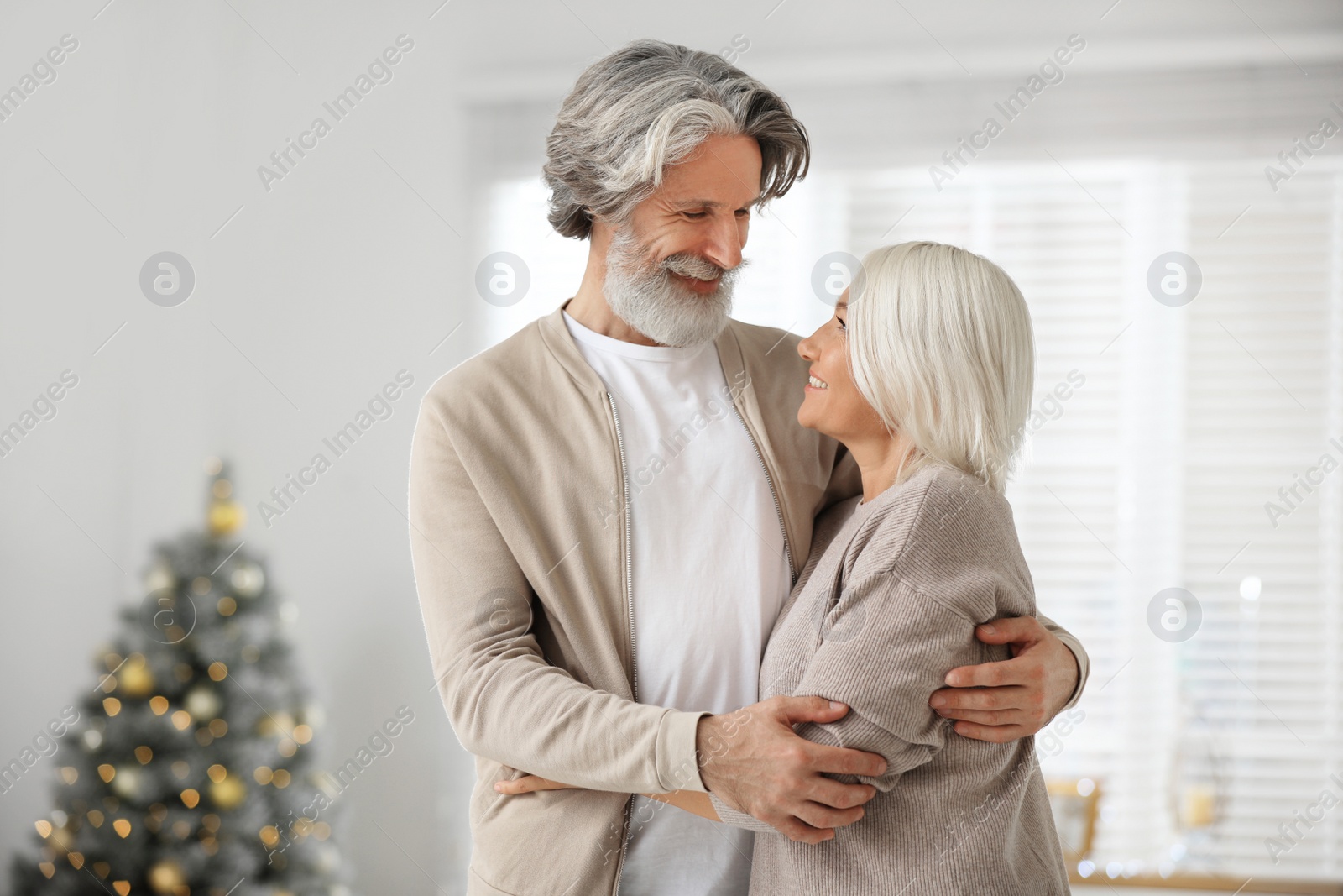 Photo of Happy mature couple celebrating Christmas at home