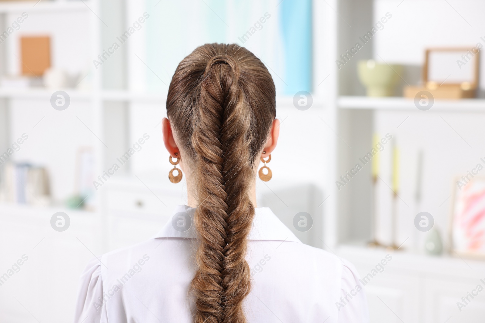Photo of Woman with braided hair at home, back view