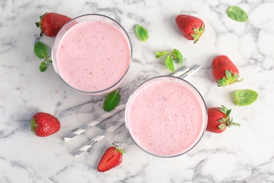 Flat lay composition with healthy detox smoothie and strawberries on marble background