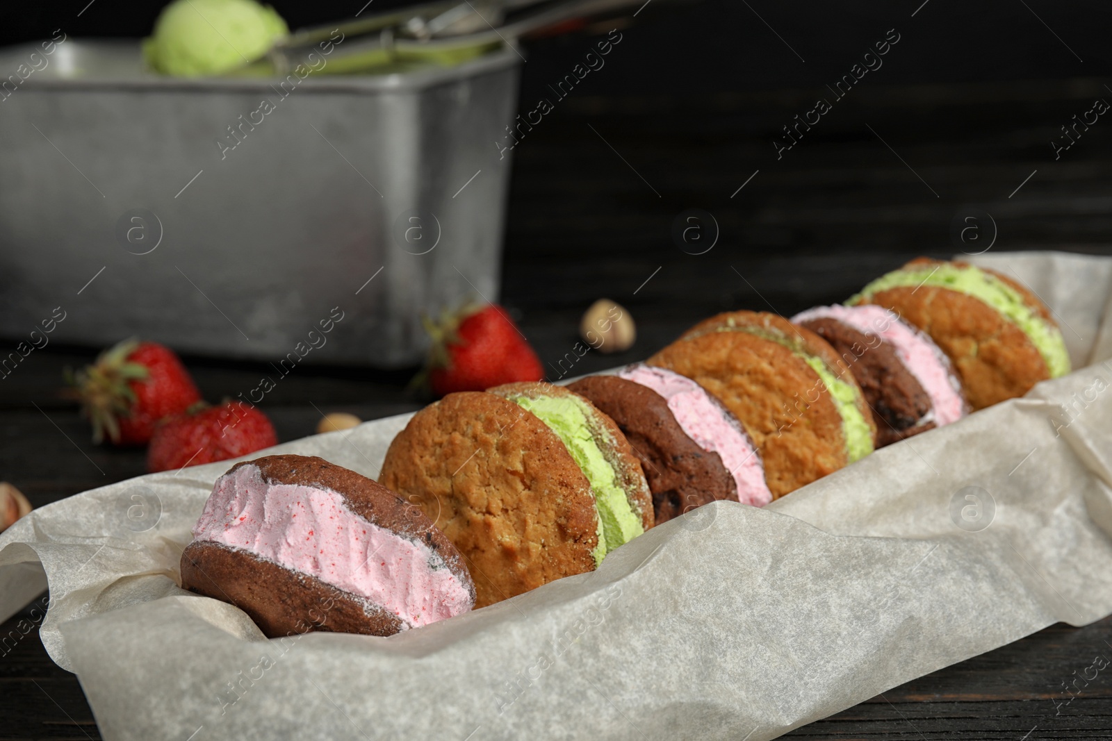 Photo of Different sweet delicious ice cream cookie sandwiches served on table