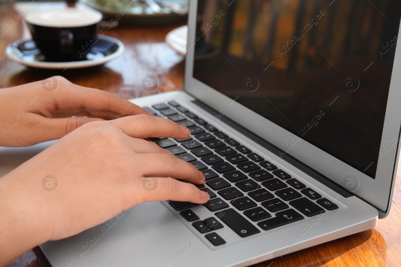 Photo of Woman using laptop in cafe, closeup. Blogger at work