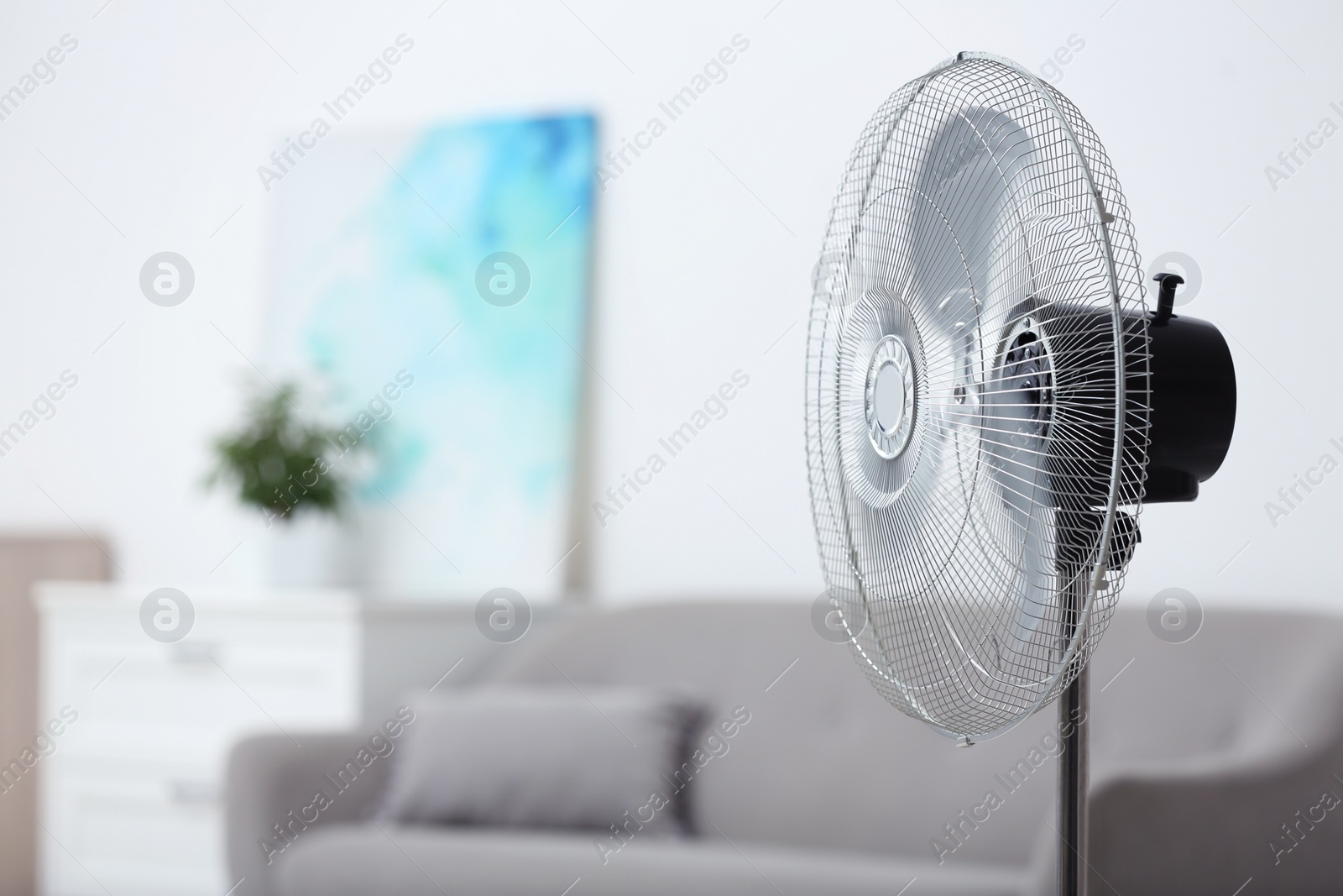 Photo of Modern electric fan in room. Space for text