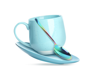 Image of Clean turquoise cup with saucer and teaspoon in flight on white background
