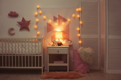 Baby bedroom interior with crib and beautiful decor elements