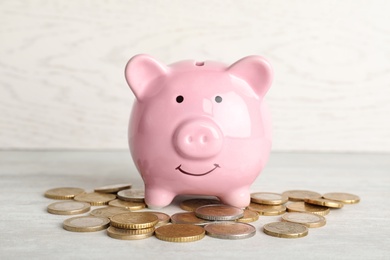 Piggy bank with coins on light table