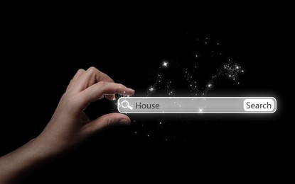 House hunting. Woman holding virtual search bar on black background, closeup