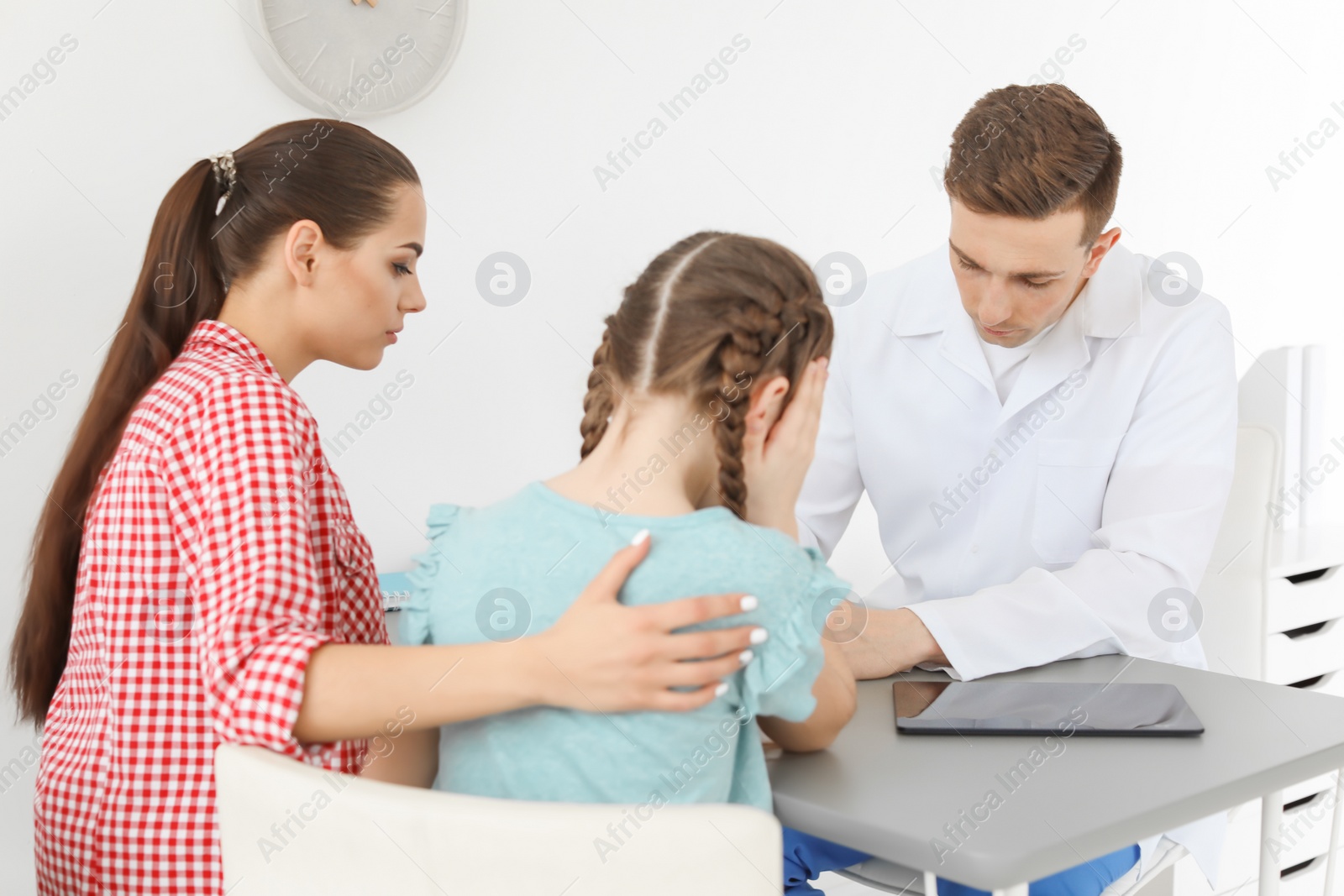 Photo of Young woman with her daughter having appointment at child psychologist office