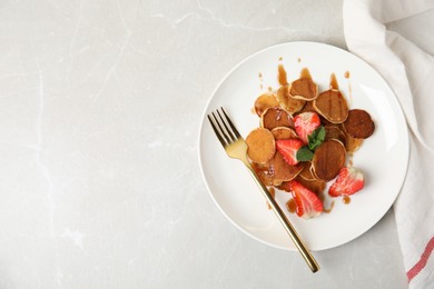 Cereal pancakes with strawberries on light grey marble table, flat lay. Space for text