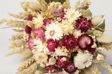 Beautiful bouquet of dry flowers on white background, closeup