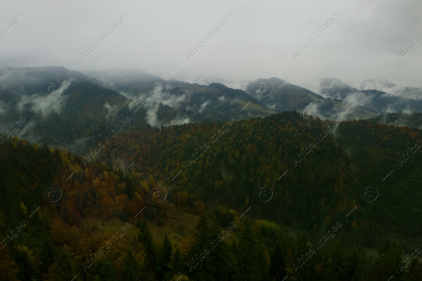 Image of Aerial view of mountains covered with fog
