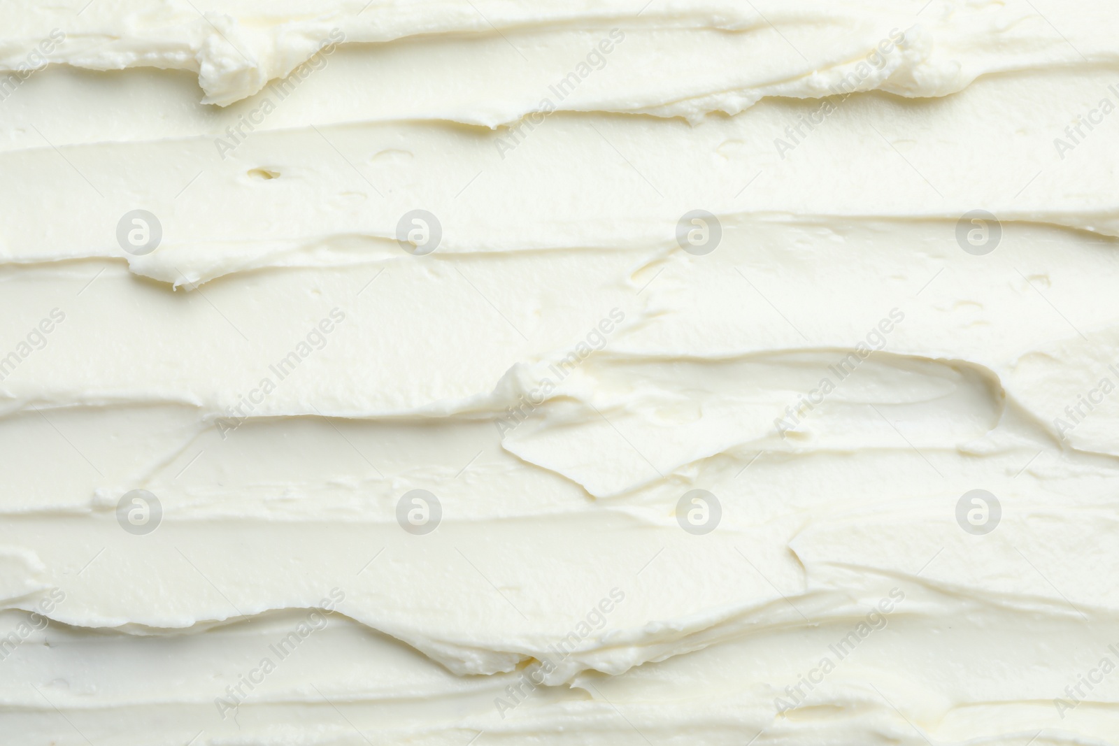 Photo of Closeup of tasty cream cheese as background, top view