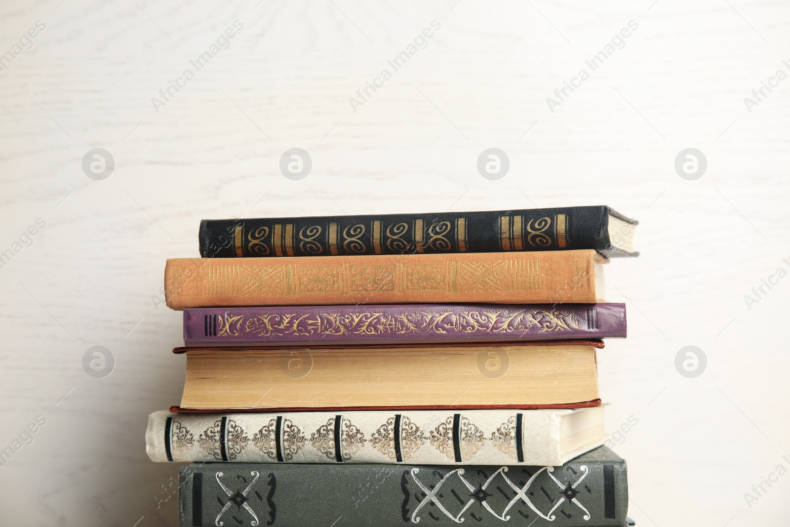 Photo of Collection of different books on white wooden background