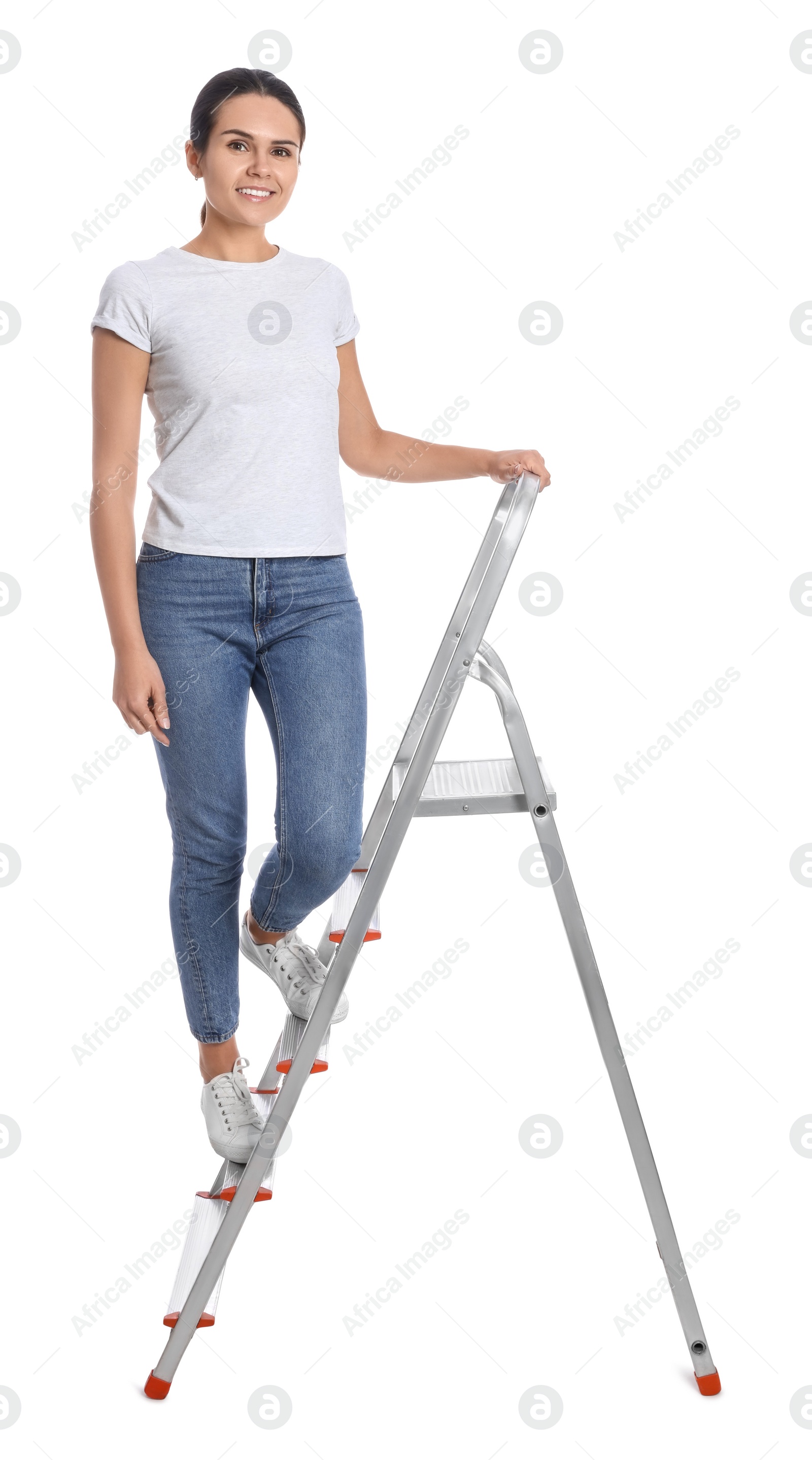 Photo of Young woman on metal ladder against white background