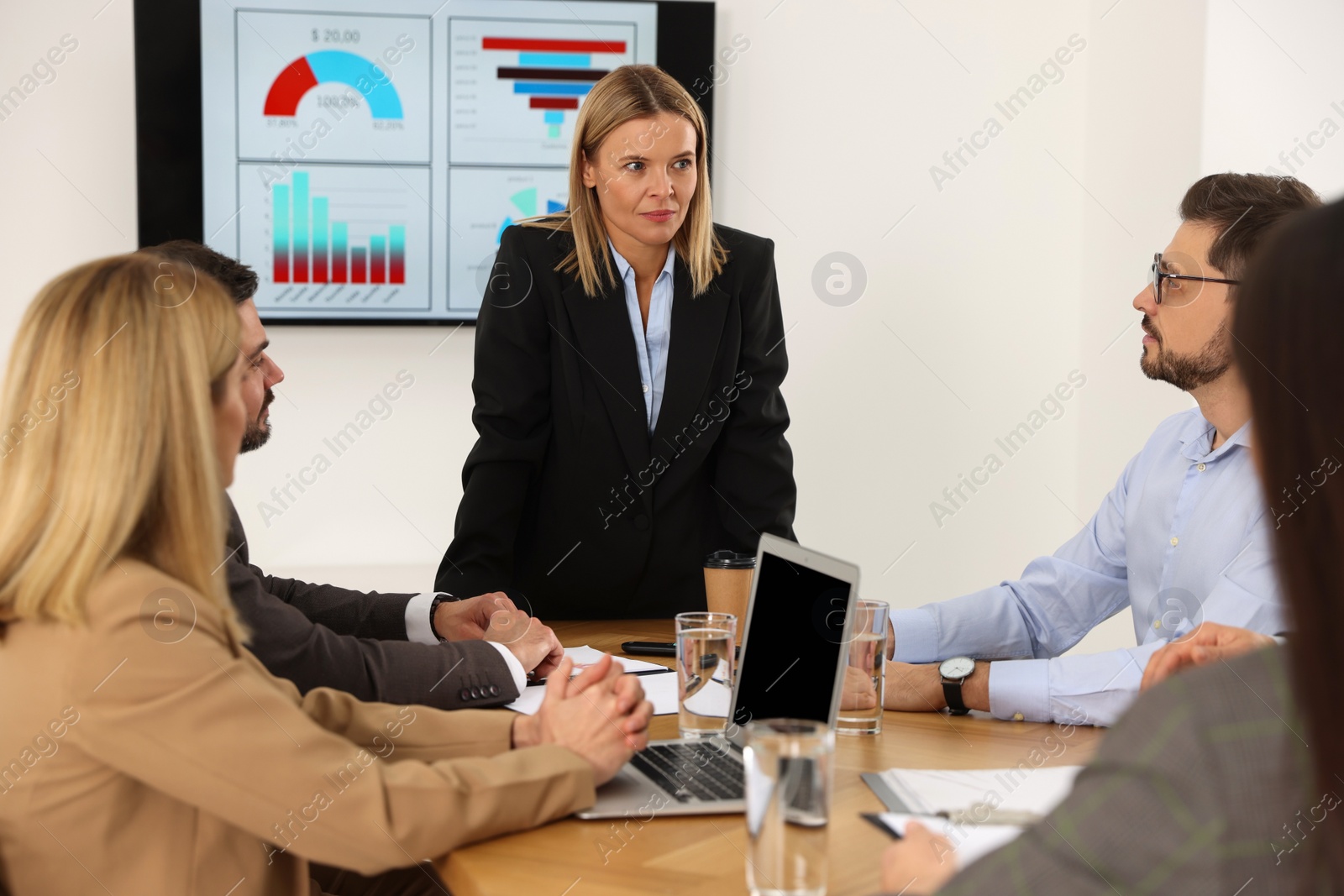 Photo of Businesswoman having meeting with her employees in office