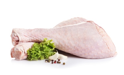 Photo of Raw turkey drumsticks and ingredients on white background